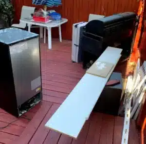 Old appliances and household items on deck awaiting junk removal in Alexandria VA