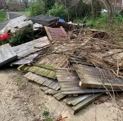 Yard and deck debris ready for removal in Alexandria Pile of wood planks, fence panels, and garden debris for junk removal in Alexandria
