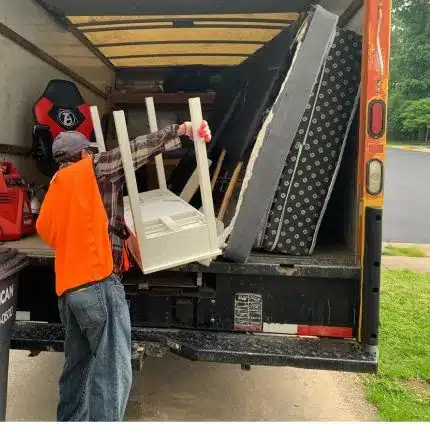 MA Junk Removal & Cleaning Services – Professional Junk Pickup Team loading unwanted items and furniture into junk removal truck