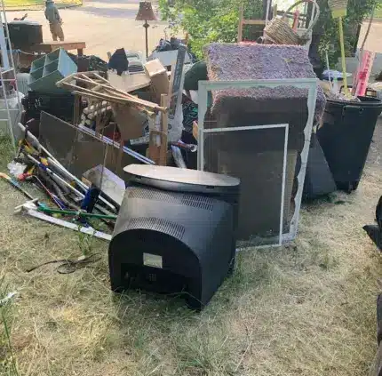 Discarded old TV and mixed electronic waste set out for removal in Arlington VA