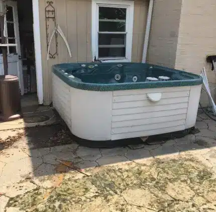 Hot Tub Removal in Arlington – MA Junk Removal & Cleaning Services Old hot tub outside Arlington home ready for removal