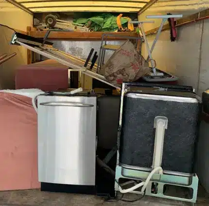 Old appliances and bulky junk loaded in truck for removal in Centreville VA