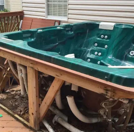 Broken outdoor hot tub with exposed pipes ready for removal in Centreville VA
