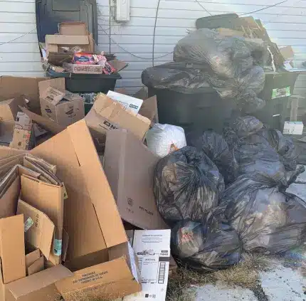 Overflowing trash bags and cardboard boxes ready for junk removal in Centreville VA