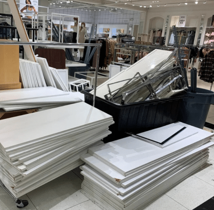 Stacked white retail panels and metal fixtures cleared during Centreville commercial junk removal service