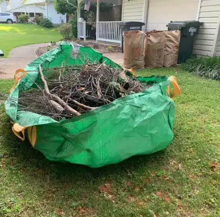debris bag filled with tree branches and yard waste on a residential lawn in Virginia