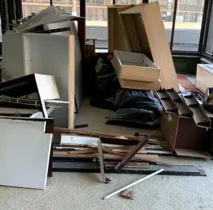 broken furniture and debris piled for removal during estate cleanout
