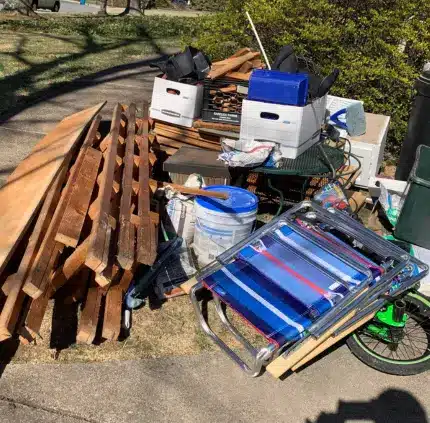 Junk removal in Burke VA with wood planks, boxes, and miscellaneous household items ready for disposal