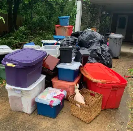 Junk removal in McLean VA with plastic storage bins, trash bags, and household clutter ready for disposal
