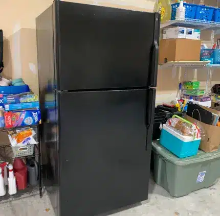 Appliance Removal in Springfield – MA Junk Removal & Cleaning Services Old black refrigerator stored in garage awaiting removal in Springfield VA