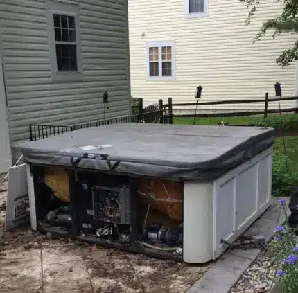 Old broken hot tub with exposed components ready for removal in Virginia