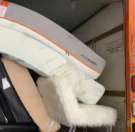 Old mattresses and chair loaded in truck for removal across Virginia