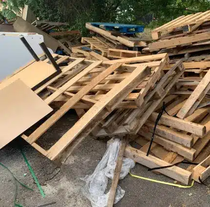Yard junk removal in McLean VA with stacked wooden pallets and outdoor debris ready for haul away